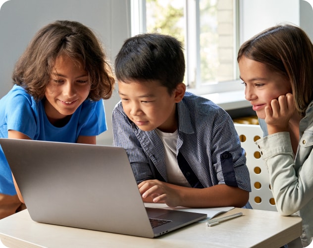 three students working on laptop