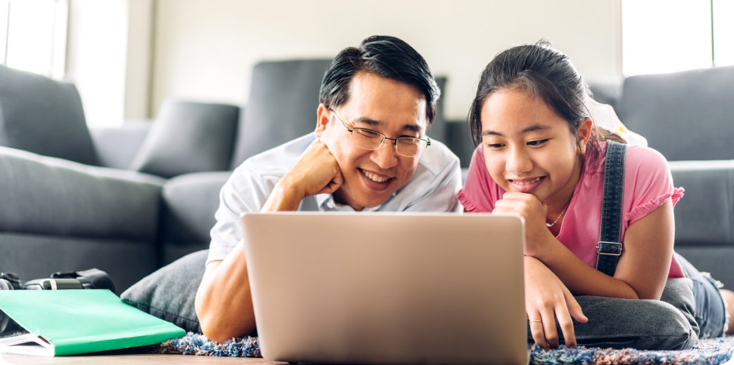 parent and student working on a laptop