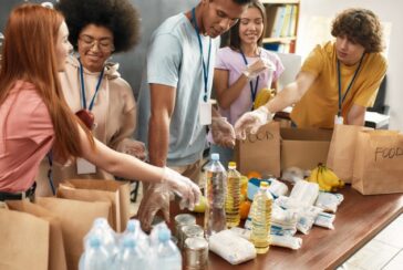 group of friends volunteering and packaging food