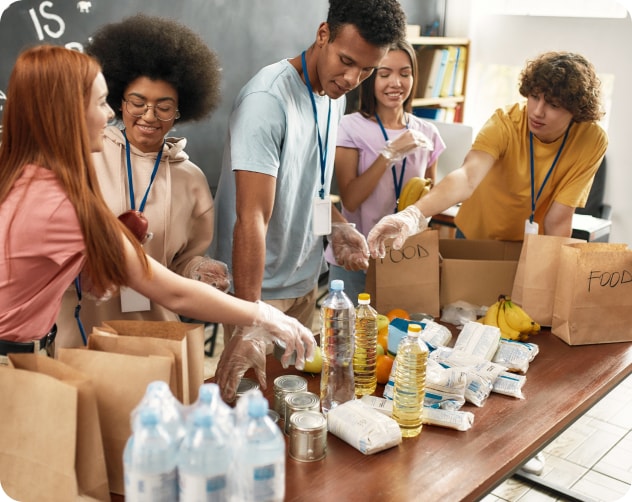 group of friends volunteering and packaging food