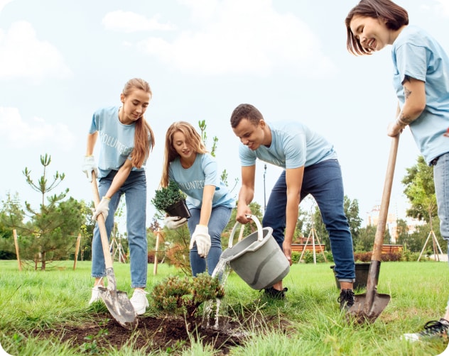 group of friends planting new trees