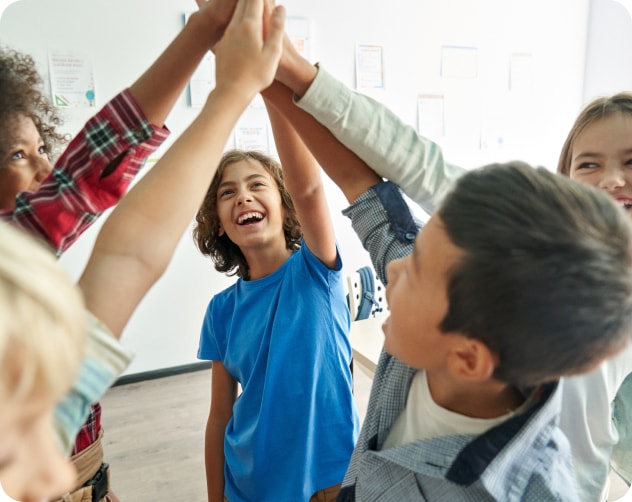 group of kids high fiving one another