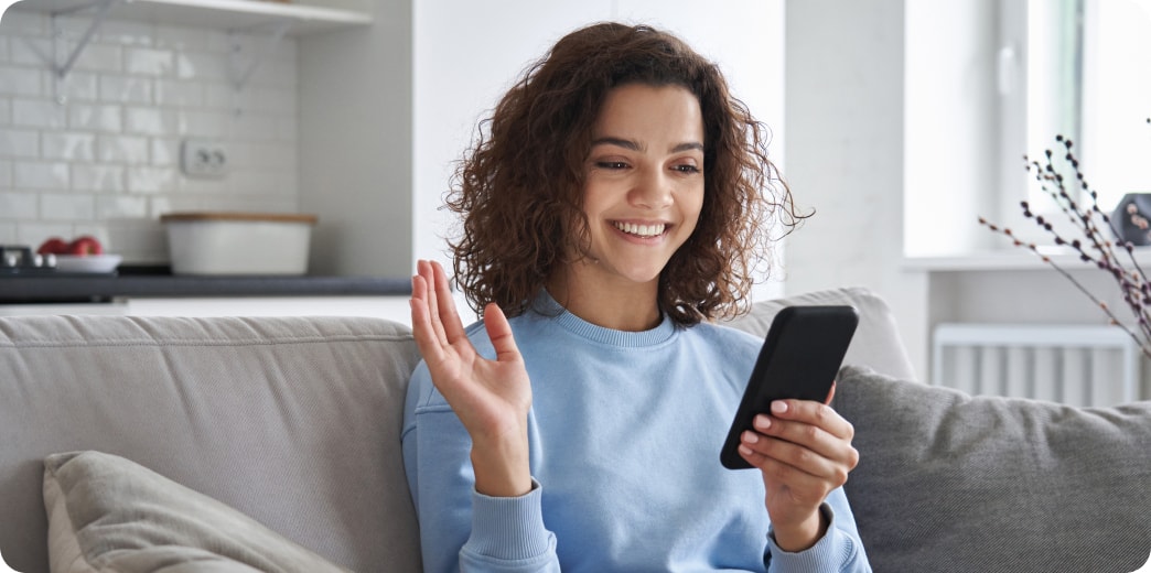 student smiling at her cell phone