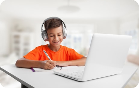 kid writing in notebook and wearing headphones