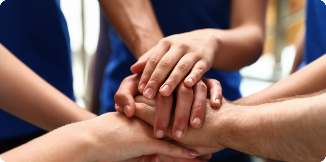 group of students stacking their hands