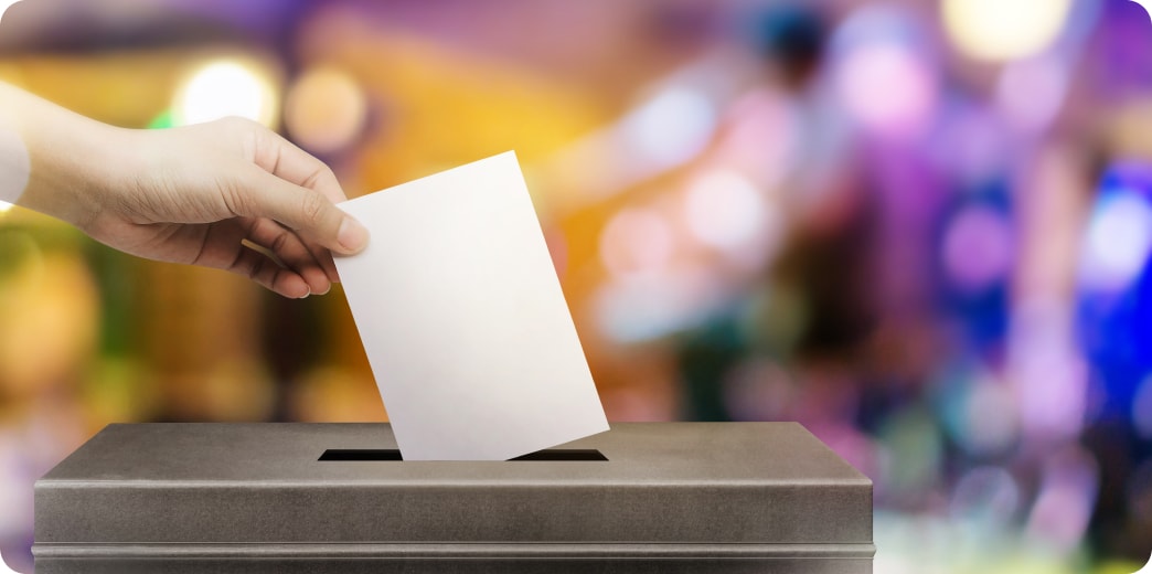 woman putting vote into box