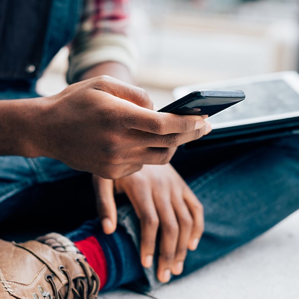 close up of student editing video on phone