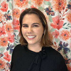 portrait of maria seitz in front of a floral background