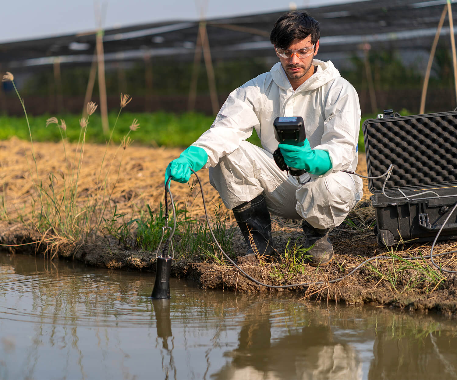 man checking water quality