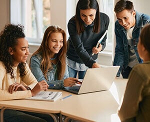 teacher working with high school students