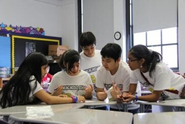 Students working together in classroom (2013-01-26 Education Rainbow Challenge 238 by dynamojon is licensed under CC BY-SA 2.0)
