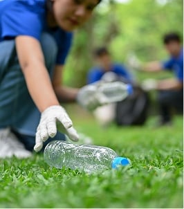 student picking up litter
