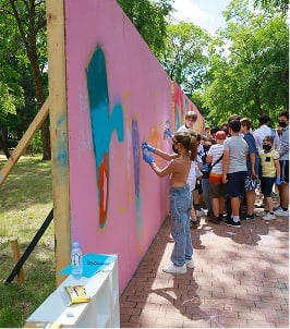 student painting a mural