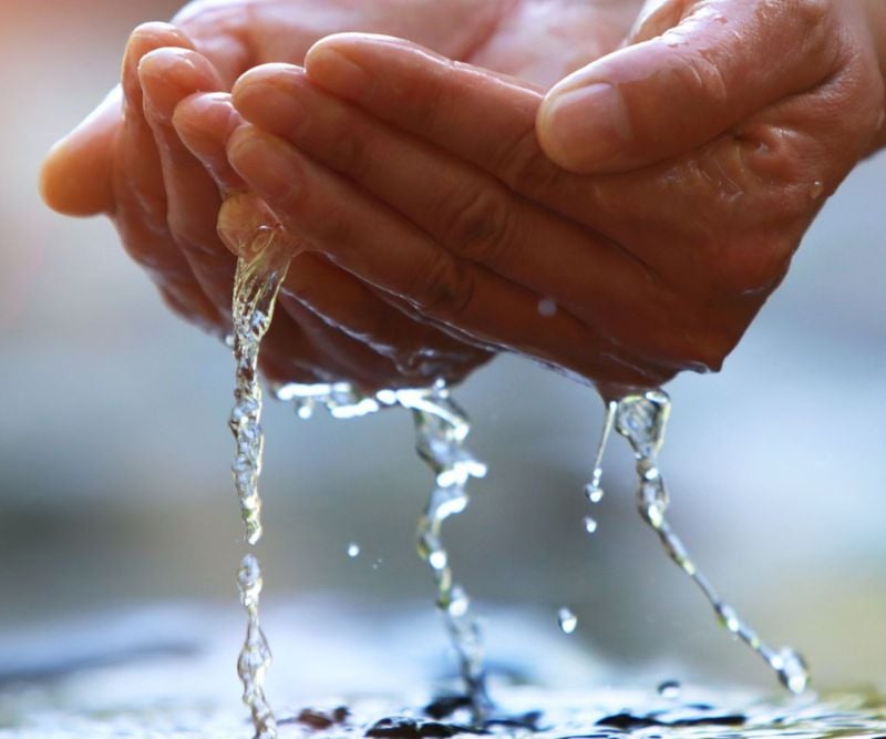 Hands scooping water
